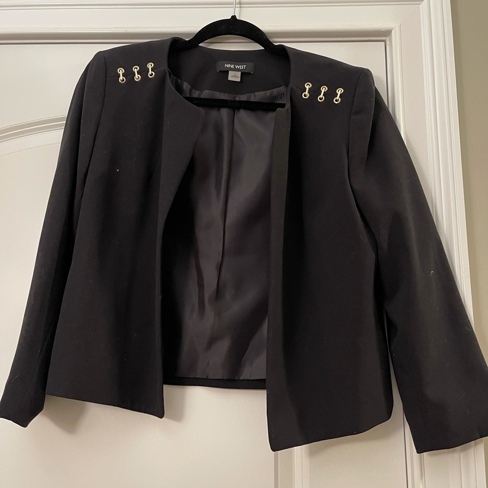 Black blazer with gold metal serial on padded shoulders